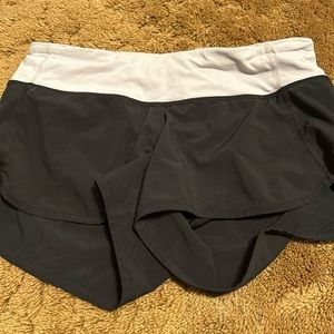 Size 4 black Lululemon shorts with a white waistband great condition 2.5 inch